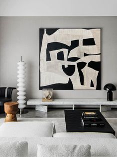 a living room filled with furniture and a painting on the wall