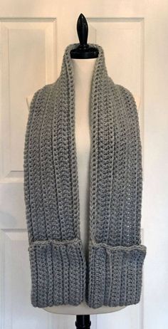 a gray knitted scarf on a mannequin