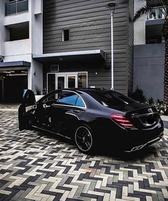 a black car parked in front of a building