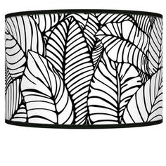 a black and white lamp shade with leaves on it