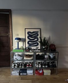 there are many pairs of shoes on the shelf in this room, and one is empty