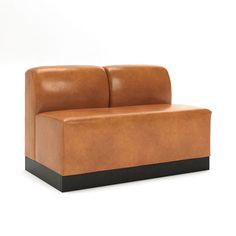 a brown leather couch sitting on top of a white floor next to a black base