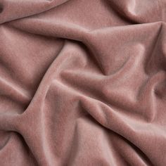 a close up view of a pink colored fabric with very soft folds and wrinkles