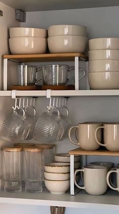 the shelves are filled with dishes and cups