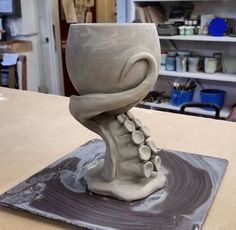 a sculpture of a shoe on top of a table