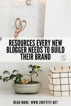 there is a potted plant on the counter next to scissors and a bag with text that reads resources every new blogger needs to build their brand