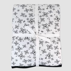 a white blanket with skulls and stars on it