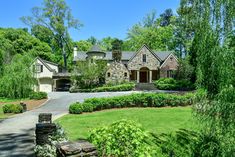 a large house surrounded by lush green trees