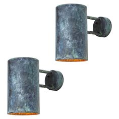 two metal wall lights with rusted finish on them, one light is orange and the other is green