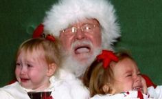 two children and an older man dressed as santa claus