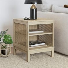 a living room scene with focus on the end table and shelf next to the couch