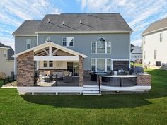 a large house with a covered patio and grill