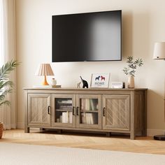 a flat screen tv mounted to the side of a wooden cabinet in a living room