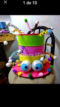 a colorful hat that is sitting on top of a chair with beads and beads around it