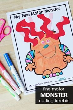 this is an image of a monster coloring page with scissors and crayons on the table