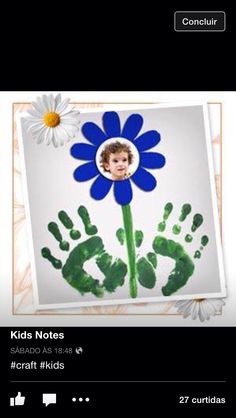 a child's hand and foot prints with a blue flower in the center, surrounded by white daisies