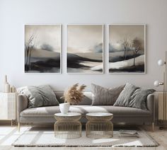 a living room with three paintings on the wall