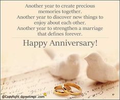 two wedding rings sitting next to each other on top of a piece of paper with the words happy anniversary