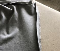 a close up view of the back of a couch with fabric on it's side