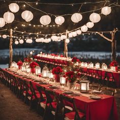 a long table is set up with red linens and lanterns