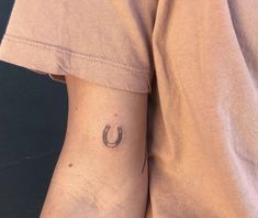 a man with a horseshoe tattoo on his arm