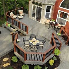 a deck with table and chairs on it