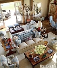 a living room filled with lots of furniture in it's centerpiece and windows