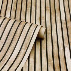 a close up view of a tie on a wooden surface with black and white stripes