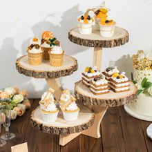 three tiered cake stand with cupcakes and flowers on it next to other desserts