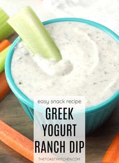 greek yogurt ranch dip in a blue bowl with celery and carrots