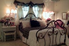 a bedroom with a bed and chandelier in it