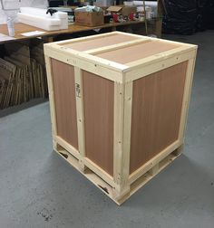 a large wooden box sitting on top of a floor