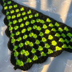 a crocheted green and black piece of cloth