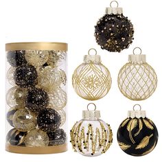 christmas ornaments are in a glass container with gold trimmings and black baubles