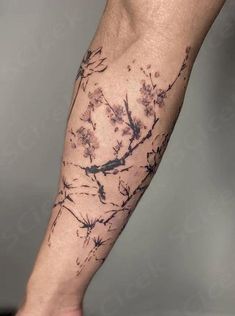 a person's arm with tattoos on it and flowers in the middle of their arm