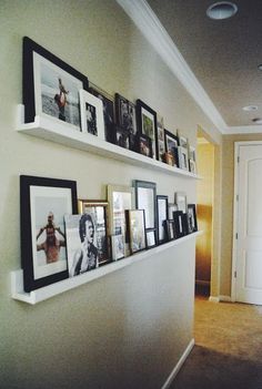 the wall is lined with pictures and framed photographs