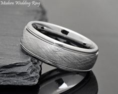 a wedding ring sitting on top of a rock