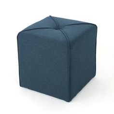 a blue cube sitting on top of a white floor