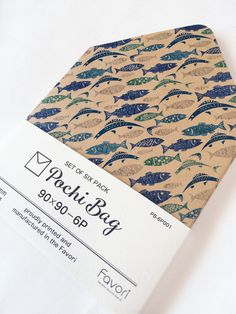 a close up of a book with fish on it's cover and an envelope