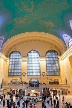 the inside of a train station filled with people