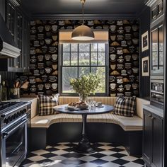 a kitchen with black and white checkered flooring next to a window covered in wallpaper