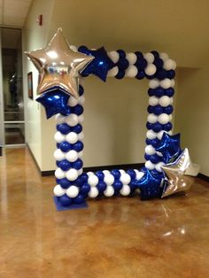 an inflatable balloon frame with stars and streamers on the floor next to it