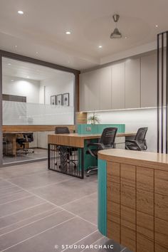 an office with desks, chairs and cabinets in the middle of the floor area