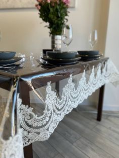 the table is set with black plates and silverware