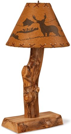 a lamp that is made out of wood and has a moose on the log underneath it