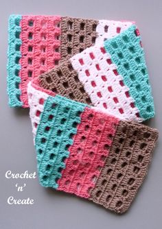 four crocheted coasters sitting on top of a gray table next to each other