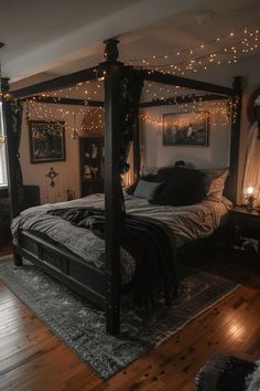 a bed sitting in a bedroom next to a window with string lights on the ceiling