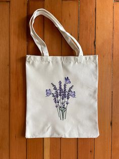 a white bag with purple flowers on it