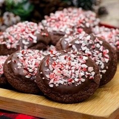 chocolate cookies with white and red sprinkles on a cutting board