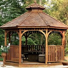 a wooden gazebo sitting in the middle of a park